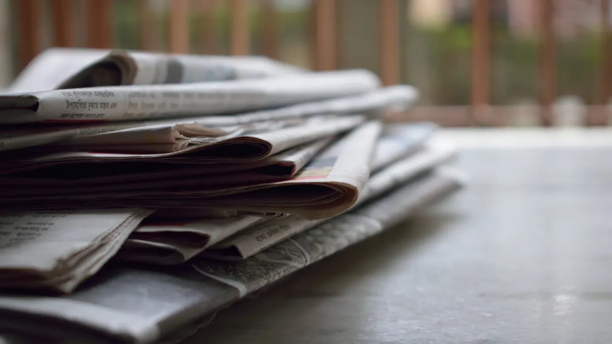 stack of newspapers on a table