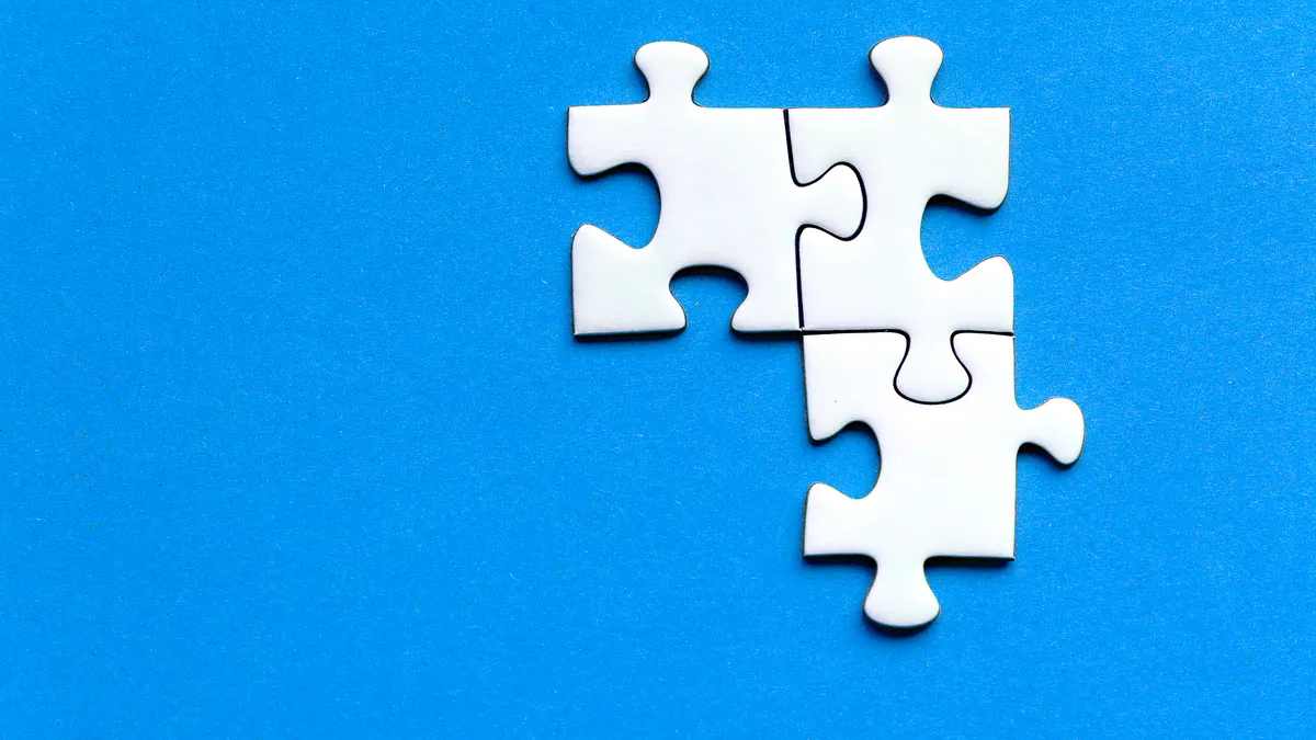 three white jigsaw pieces forming a partial cluster